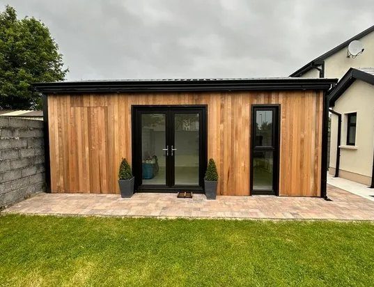 Cedar garden office with French doors on a sunny day